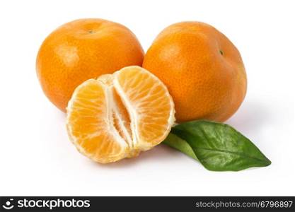Ripe mandarines with leaves close-up on a white background. Tangerines with leaves on a white background. with clipping path