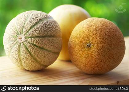 ripe melons on wooden table