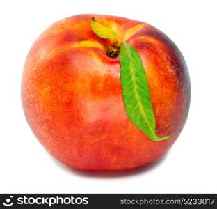 Ripe nectarine with a green leaf on a white background