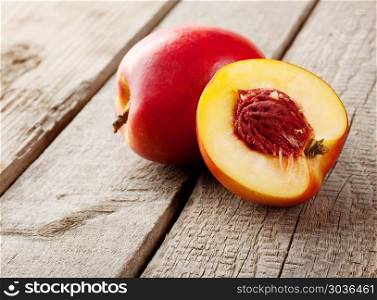 Ripe nectarines sliced on a wooden table