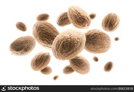 Ripe nutmegs levitate on a white background.. Ripe nutmegs levitate on a white background