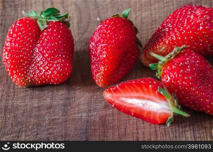 Ripe organic juicy strawberry on wooden table