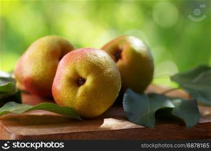 ripe organic pears on rustic wooden table