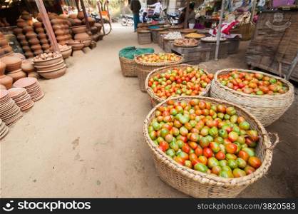 Ripe organic tomatoes for sale at outdoor asian marketplace. Bagan, Myanmar. Burma travel destinations