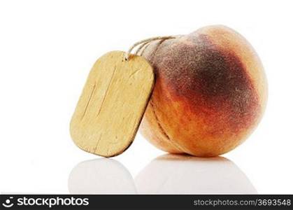 ripe peach with tag isolated on white background