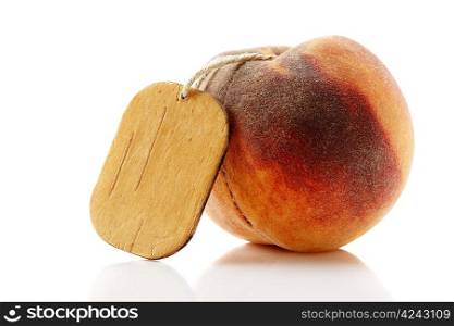 ripe peach with tag isolated on white background