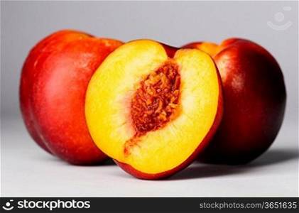 ripe peaches on gray background