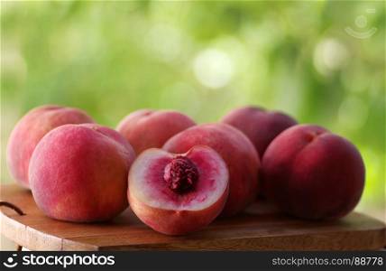 ripe peaches on wooden table