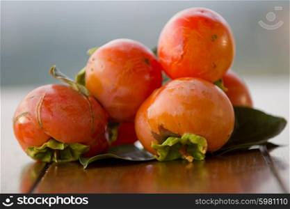 ripe persimmons on a table, outdoor