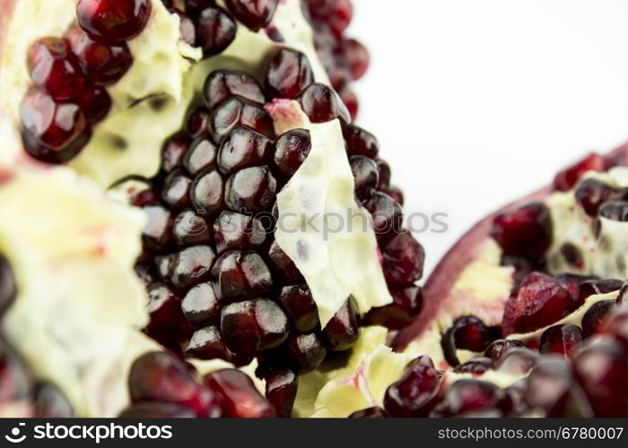 Ripe pomegranate fruit and part isolated on white background .