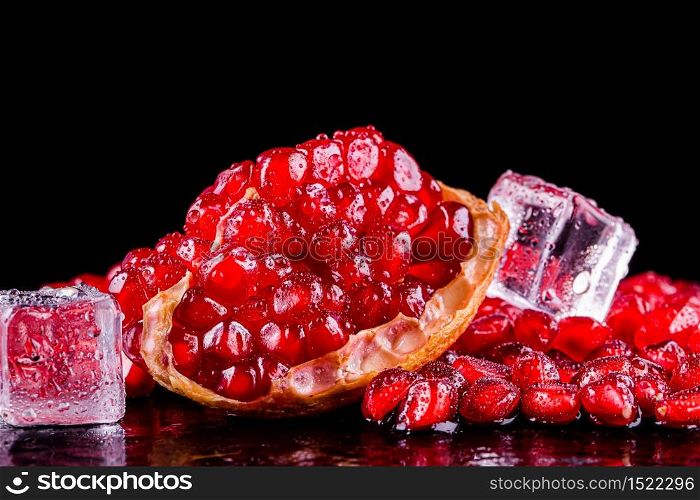 Ripe pomegranate fruits on the wooden background