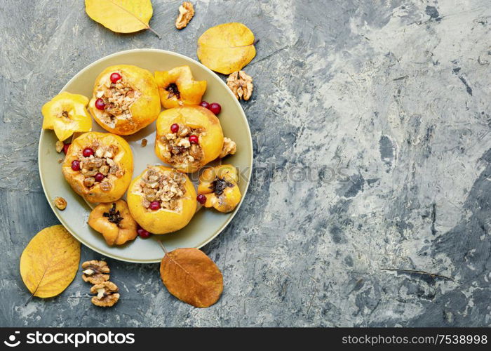 Ripe quince baked with nuts and raisins.Autumn dessert.Baked apples. Tasty baked quince