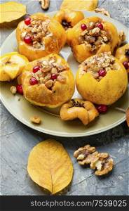 Ripe quince baked with nuts and raisins.Autumn dessert.Baked apples. Tasty baked quince