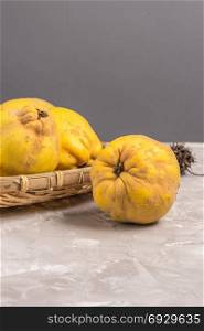 Ripe quince fruits on kitchen countertop.