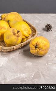 Ripe quince fruits on kitchen countertop.
