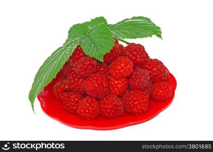 Ripe raspberries decorated with green leaf in a small platter
