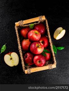 Ripe red apples in a basket. On a black background. High quality photo. Ripe red apples in a basket.