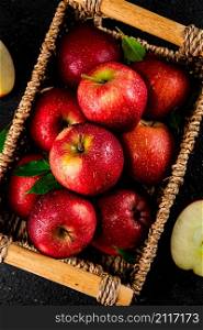 Ripe red apples in a basket. On a black background. High quality photo. Ripe red apples in a basket.