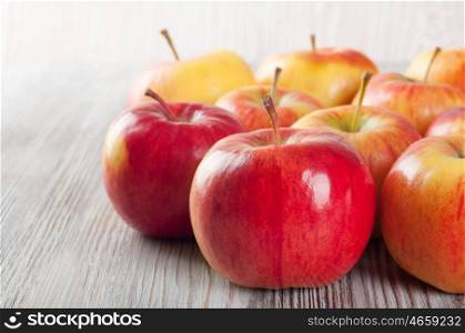 Ripe red apples on a wooden background. Juicy apples on a table.