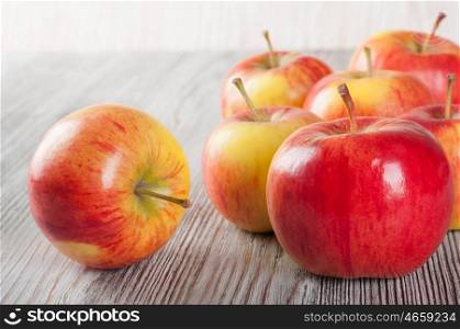 Ripe red apples on a wooden background. Juicy apples on a table.