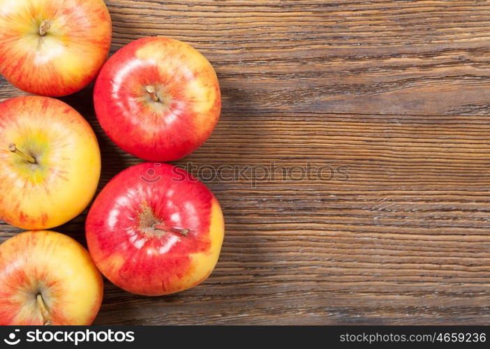 Ripe red apples on a wooden background. Top view.