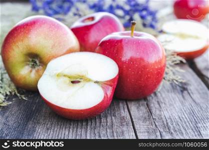 Ripe red apples on a wooden table. Vitamins and a healthy diet. Vegetarian concept. Close-up.. Ripe red apples on a wooden table. Vitamins and a healthy diet. Vegetarian concept.