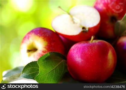 ripe red apples on table, green background