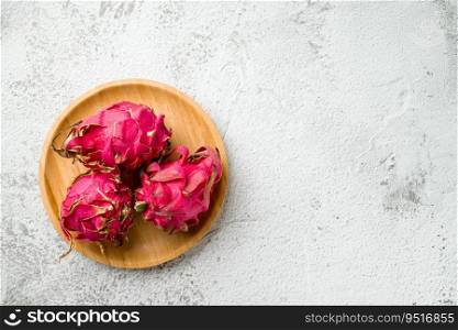Ripe red dragon fruit on stone table