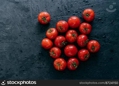 Ripe red fresh tomatoes with water drops isolated on black background. Heilroom vegetables. Raw food. Healthy nutrition. Rich harvest