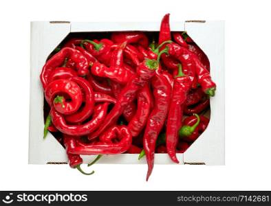 ripe red hot pepper in a white cardboard box isolated on white background, top view
