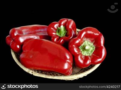 Ripe red pepper isolated over black background