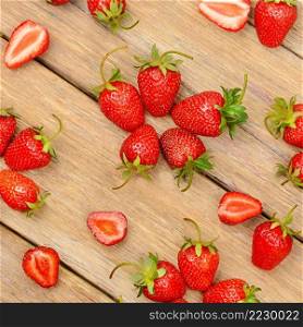 Ripe red strawberries on a wooden table. View from above.