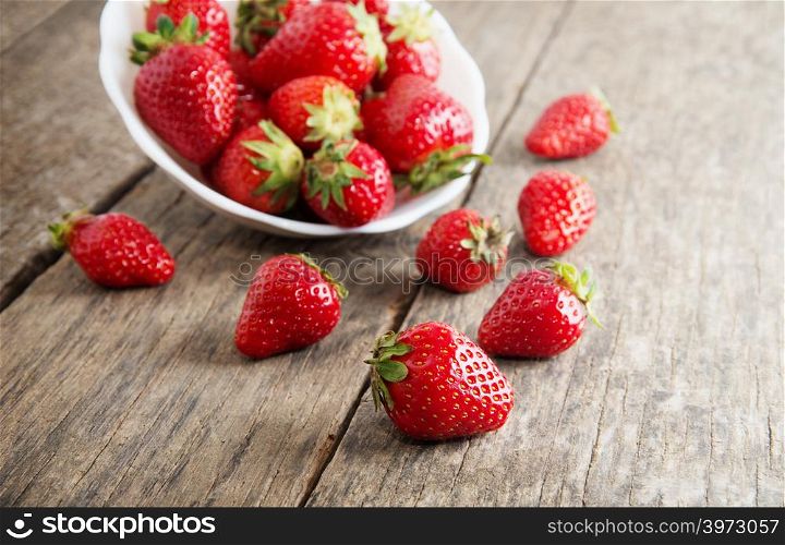 Ripe red strawberries on wooden table