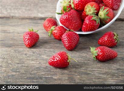 Ripe red strawberries on wooden table