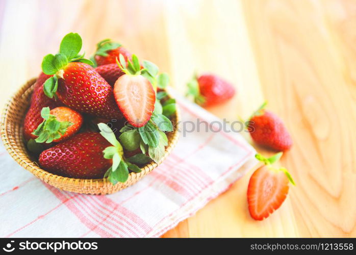 ripe red strawberry picking in basket / fresh strawberries on wooden background