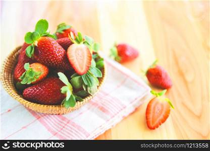 ripe red strawberry picking in basket / fresh strawberries on wooden background