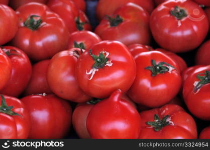 Ripe red tomatoes for sale at grocery store. Vegetables background.