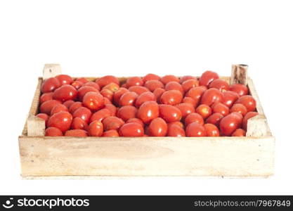 Ripe red tomatoes in wooden box isolated on white