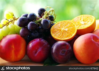 ripe sliced oranges, grappes, peaches and plums