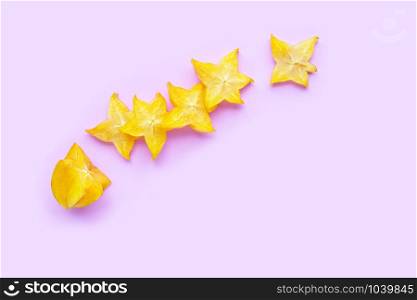 Ripe star fruit on pink background. Top view