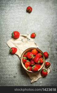 Ripe strawberries in bowl on old fabric. On the stone table.. Ripe strawberries in bowl on old fabric.