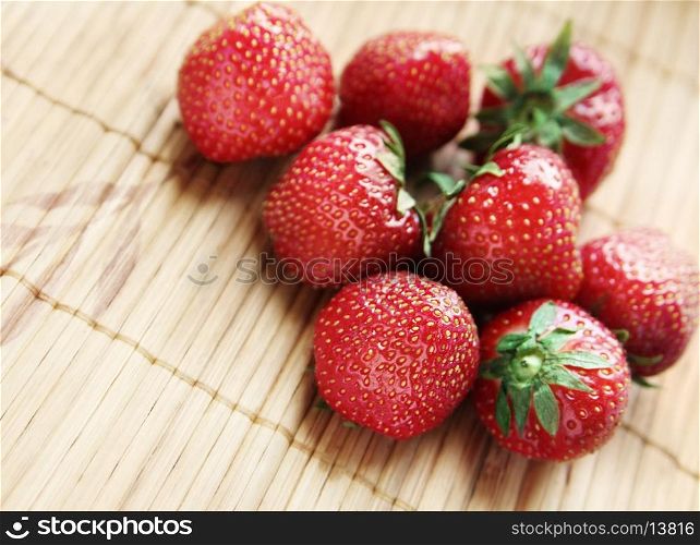 Ripe strawberries on a bamboo surface