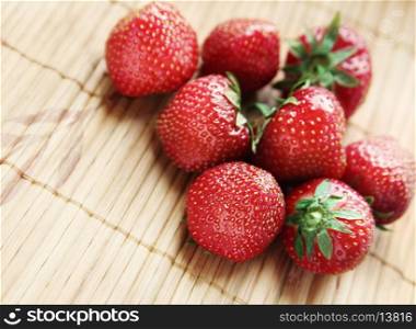 Ripe strawberries on a bamboo surface