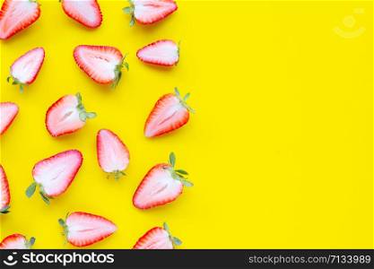 Ripe strawberries on yellow background. Copy space