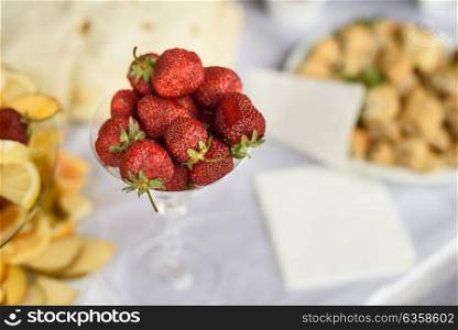 ripe strawberries with the stems lying in the bowl