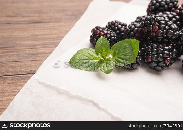 Ripe sweet blackberries on wood table background