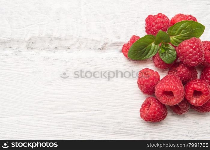 Ripe sweet raspberries on wood table background