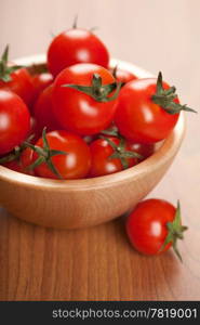 ripe tomatoes in wooden bowl