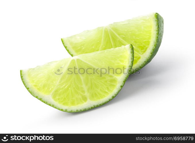 Ripe wedge of green lime citrus fruit isolated on white background. Lime slice with clipping path. green lime citrus fruit