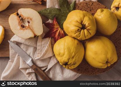 Ripe whole and sliced quinces. Fresh fruit for preparing recipes with cinnamon and lemon. An essential ingredient for a healthy diet
